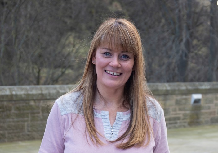 Photograph of a woman, Angela, smiling at the camera