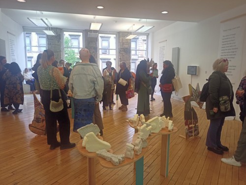 Crowd gathers at exhibition space for Monuments for Present.